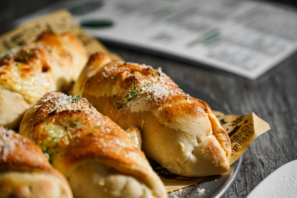 Close-up of a baked stuffed roll with cheese and herbs